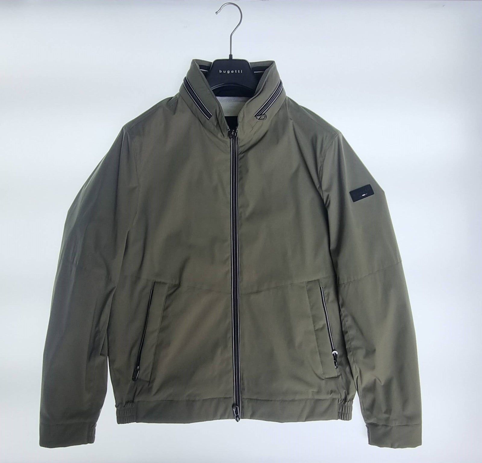 Olive green Bugatti Flexcity jacket laid flat on white background with full front zipper and stand collar