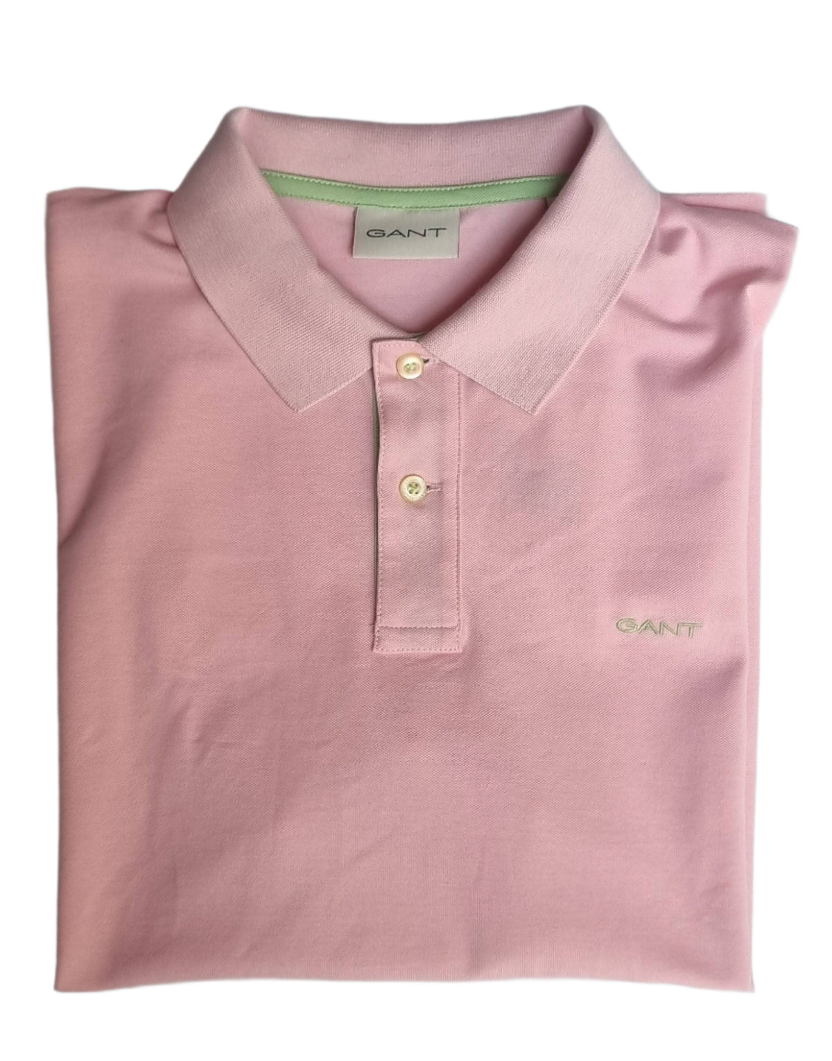 Folded pink polo shirt with Gant branding on a gray background