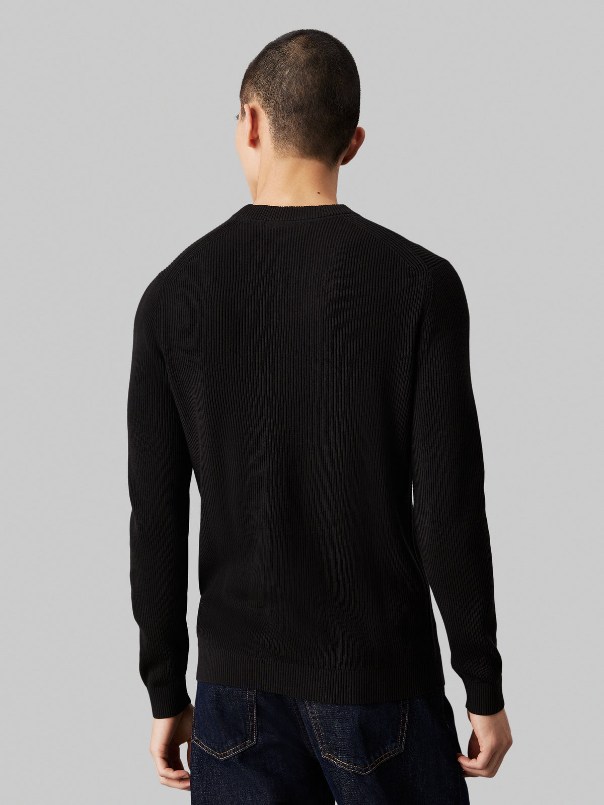 Calvin Klein Embro Badge Sweater. Featuring a soft knit fabric and iconic embroidered badge, this versatile crew neck jumper combines comfort with minimalist style.