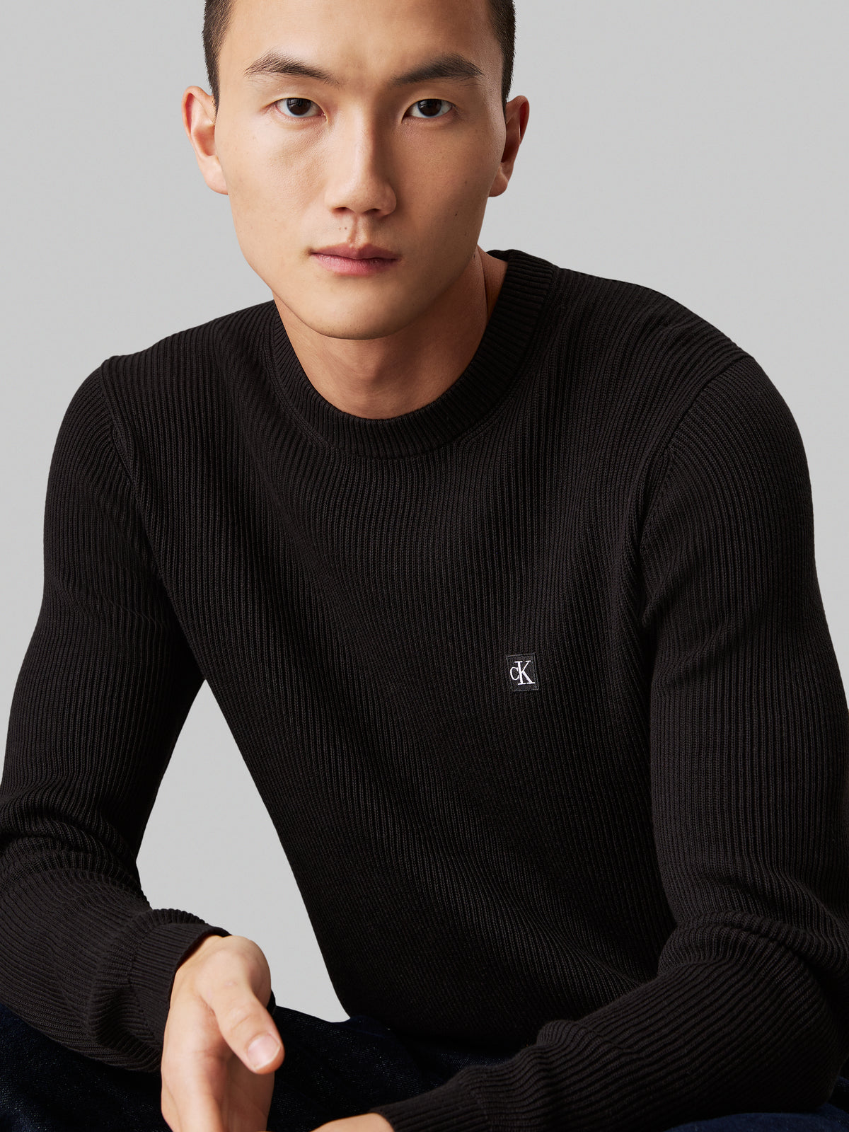 Calvin Klein Embro Badge Sweater. Featuring a soft knit fabric and iconic embroidered badge, this versatile crew neck jumper combines comfort with minimalist style.