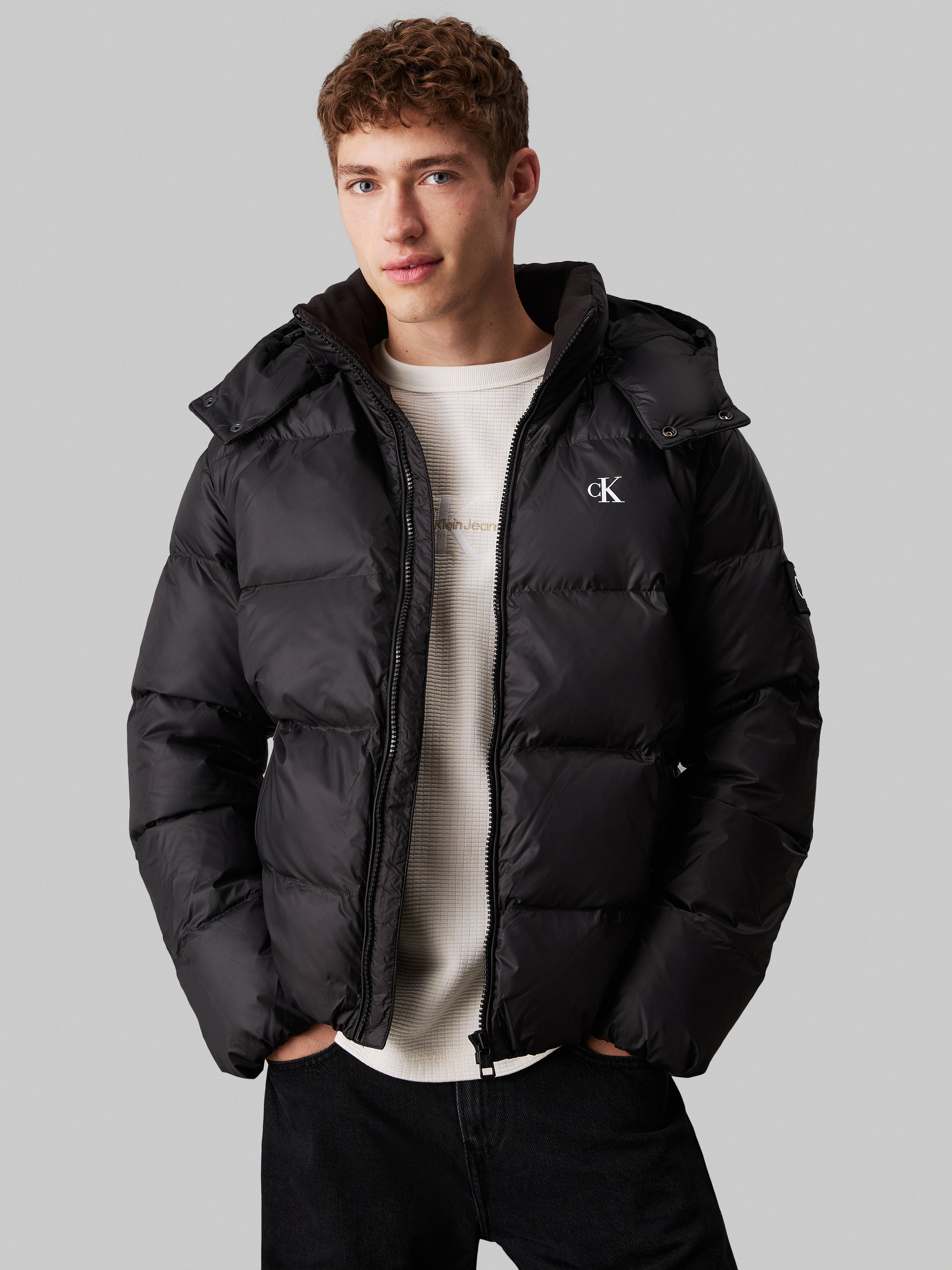 Calvin Klein Essential Down Jacket. Featuring lightweight down insulation and a sleek, minimalist design, this jacket is perfect for cold-weather comfort.