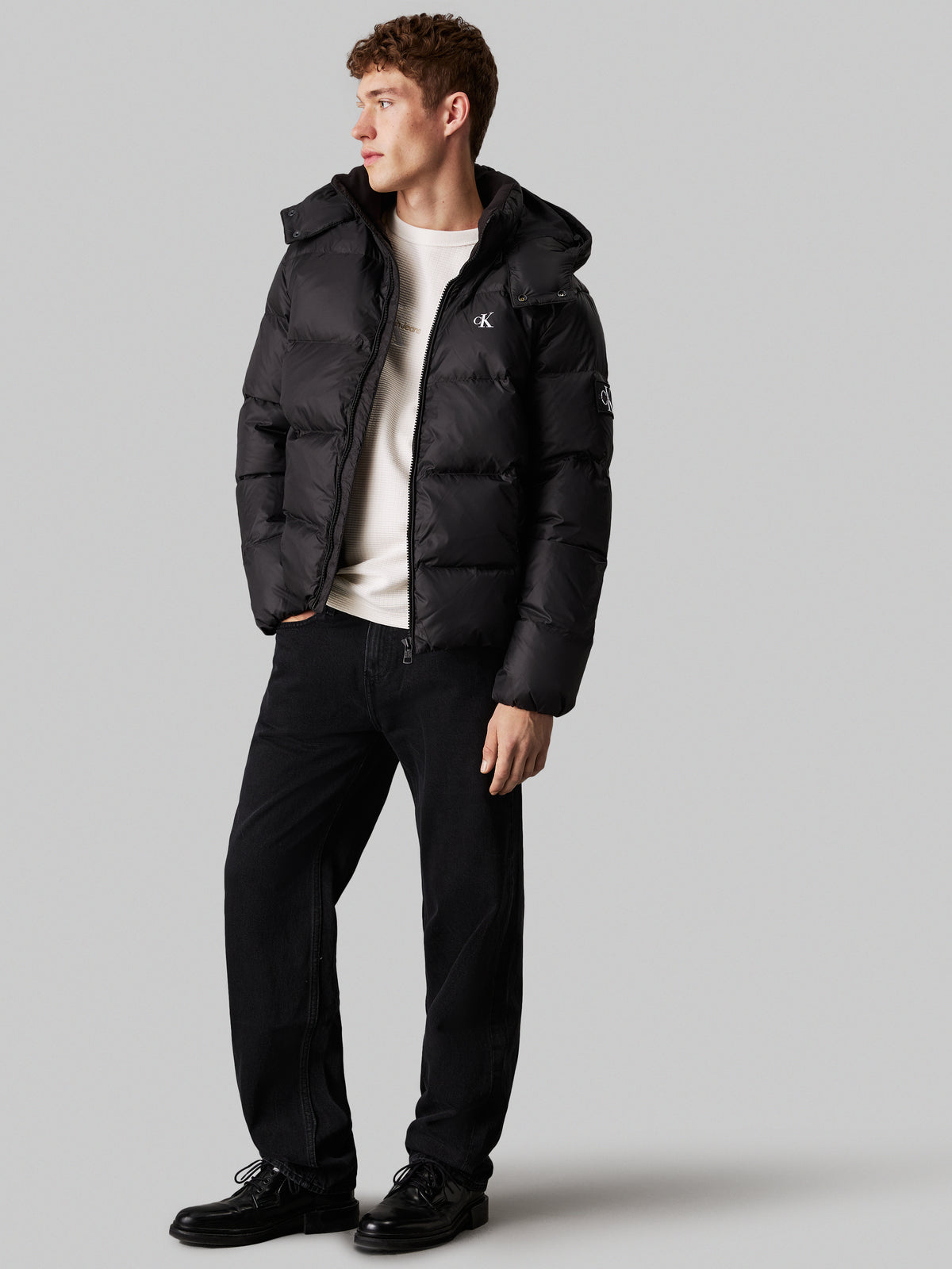 Calvin Klein Essential Down Jacket. Featuring lightweight down insulation and a sleek, minimalist design, this jacket is perfect for cold-weather comfort.