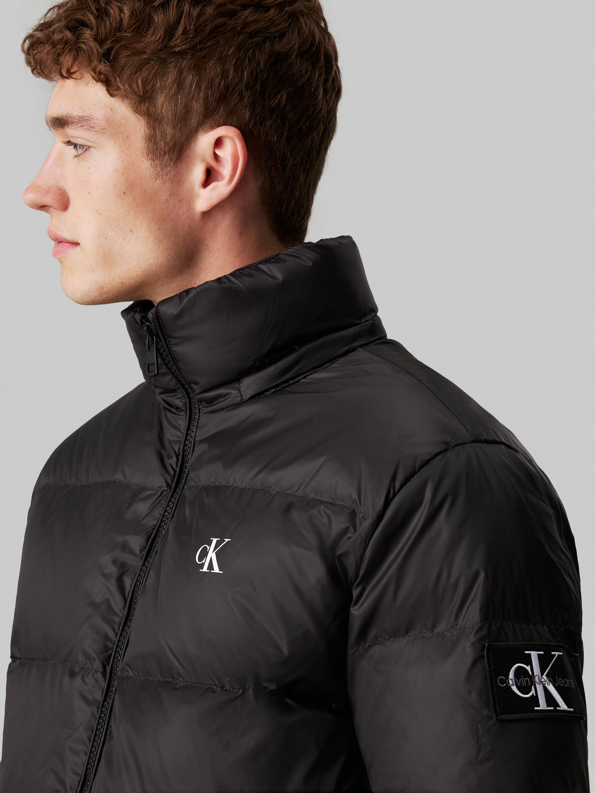 Calvin Klein Essential Down Jacket. Featuring lightweight down insulation and a sleek, minimalist design, this jacket is perfect for cold-weather comfort.