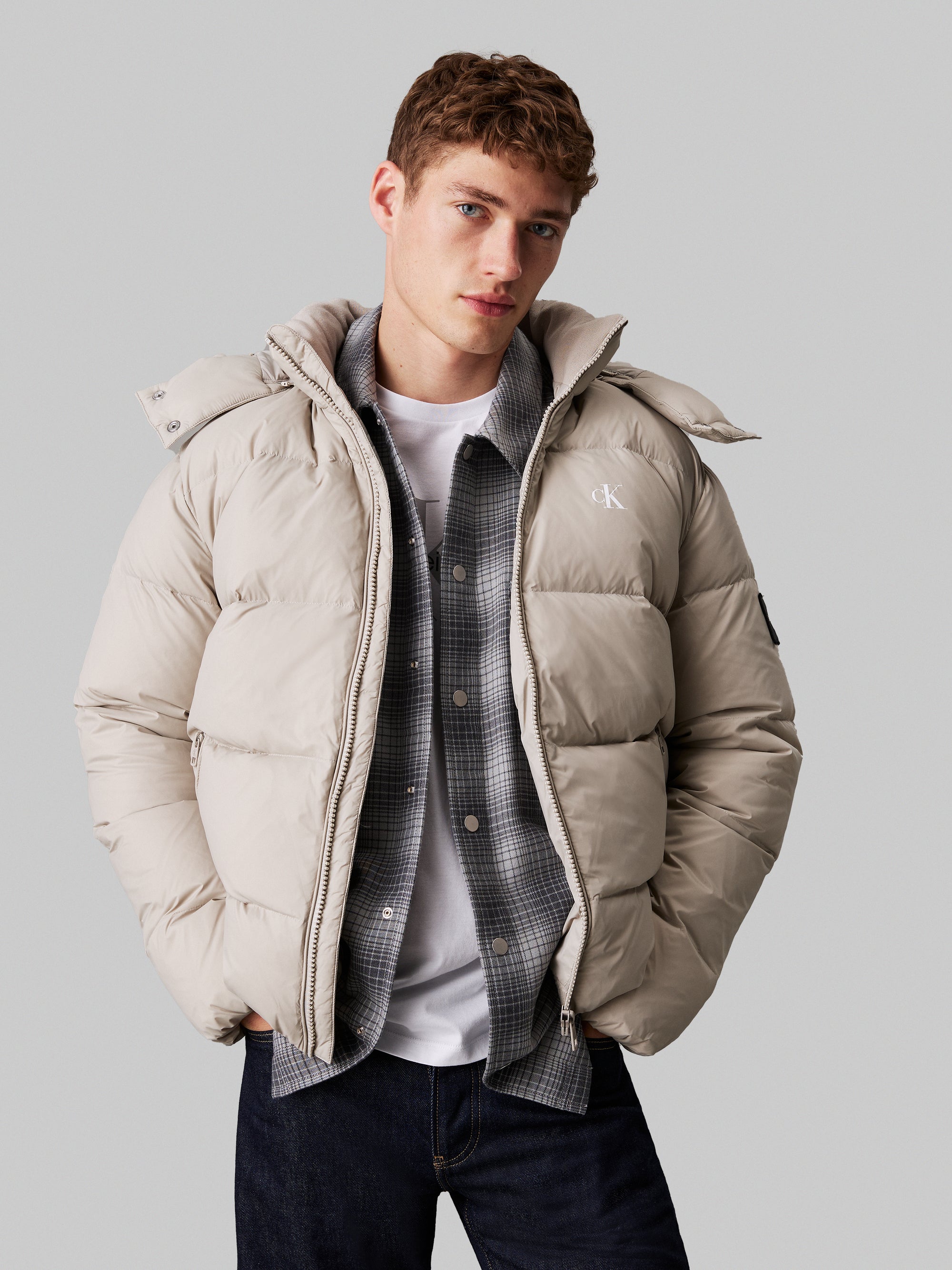 Calvin Klein Essential Down Jacket. Featuring lightweight down insulation and a sleek, minimalist design, this jacket is perfect for cold-weather comfort.