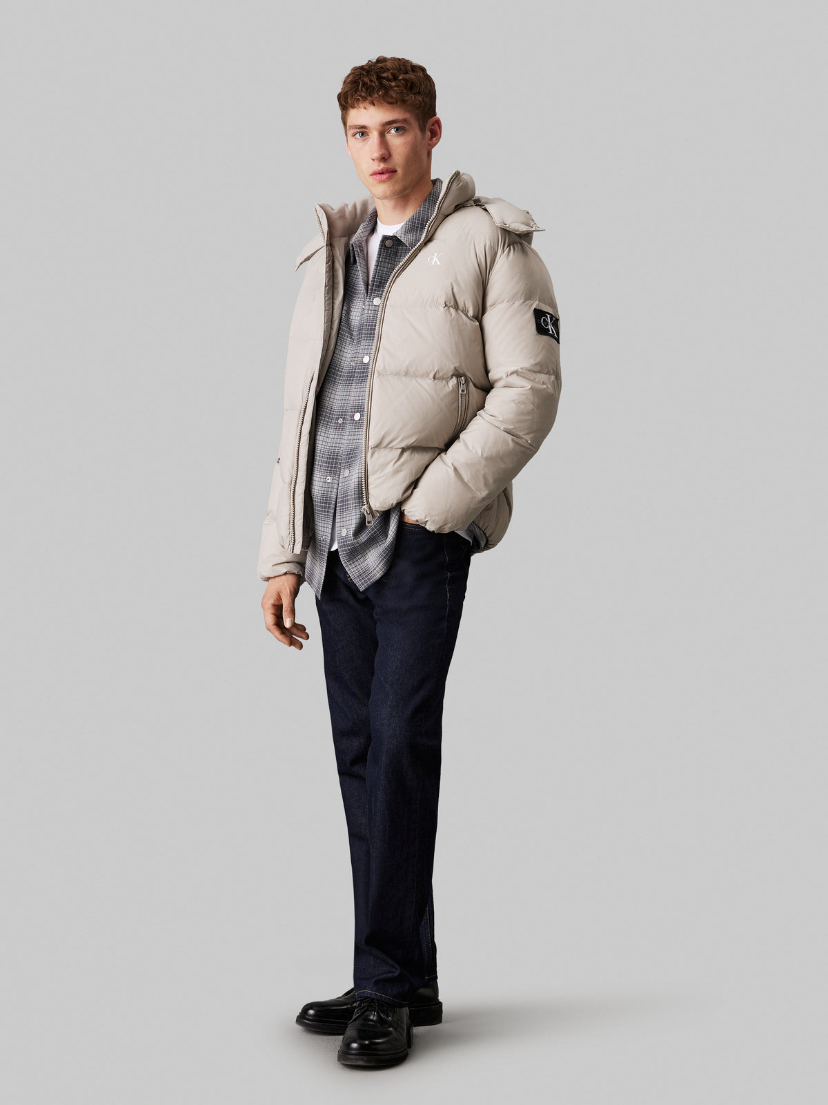 Calvin Klein Essential Down Jacket. Featuring lightweight down insulation and a sleek, minimalist design, this jacket is perfect for cold-weather comfort.