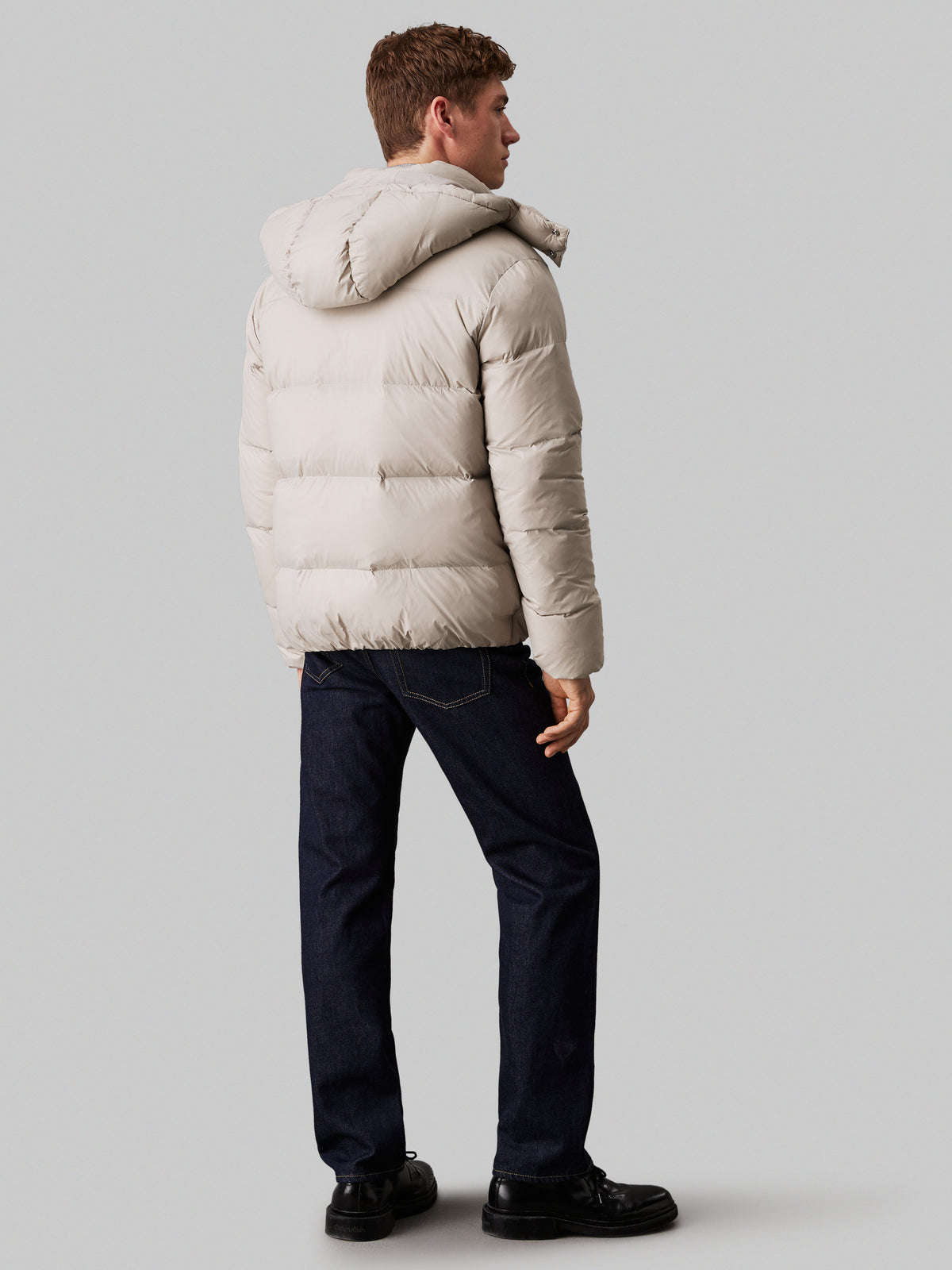 Calvin Klein Essential Down Jacket. Featuring lightweight down insulation and a sleek, minimalist design, this jacket is perfect for cold-weather comfort.